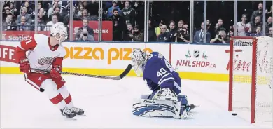  ?? STEVE RUSSELL TORONTO STAR ?? Detroit Red Wings centre Dylan Larkin scores to win the game as the Maple Leafs fall 5-4 in overtime at Scotiabank Arena in Toronto on Thursday night. The Leafs are 5-0-1 in their past six games.