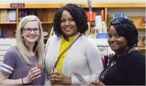  ?? (Photo by Mary Rumore, SDN) ?? Shoppers Rachel McMurry, Shequetta Gandy and Maria Snell browse at the Book Mart and Cafe during the 2018 spring unWINE Downtown.