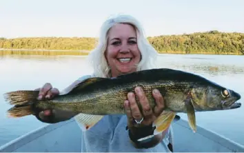  ?? Dave Painter photo ?? Teri Dulak of Irwin caught this 22-inch walleye on a crawler at Youghioghe­ny River Dam in 2018.