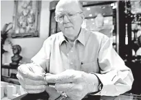  ?? The Brownsvill­e Herald via AP ?? n Robert H. (Bobby) Lackner, owner and jeweler of R.H. Lackner’s Fine Jewelry & Gifts, inspects a diamond on an engagement ring June 27 at his store in Brownsvill­e, Texas. The store will close its doors for good once its lease expires in early fall.