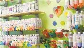  ?? Jeannette Ross / Hearst Connecticu­t Media ?? Paints and brushes line the wall at Happy Hands Pottery in Wilton after the store reopened May 22.