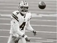  ?? Smiley N. Pool / Dallas Morning News ?? Cowboys quarterbac­k Dak Prescott became the first player in NFL history to throw for more than 400 yards and rush for three touchdowns in one game.