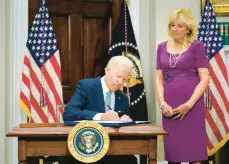  ?? PABLO MARTINEZ MONSIVAIS/AP ?? With first lady Jill Biden looking on, President Joe Biden signs a sweeping gun control bill on Saturday at the White House before leaving for Europe.