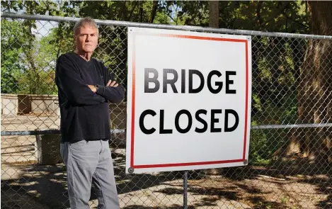  ??  ?? Jim Goulee, longtime Milwaukee parks worker and advocate, near the closed bridge over Lake Park’s Ravine Road