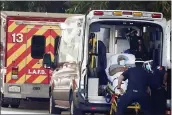  ?? MARCIO JOSE SANCHEZ — AP PHOTO ?? A patient is loaded onto an ambulance outside of the emergency entrance to PIH Health Good Samaritan Hospital on Tuesday in Los Angeles.