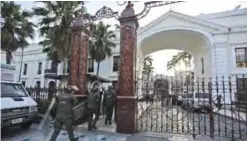  ??  ?? CARACAS: Venezuelan Bolivarian National Guard soldiers dressed in riot gear enter the National Assembly building in Caracas. Opposition lawmakers got into fisticuffs with national guardsmen as they tried to enter the National Assembly. —AP