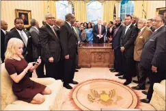  ?? Brendan Smialowski / AFP via Getty Images ?? This 2017 photo of Counselor to the President Kellyanne Conway checking her phone in the Oval Office went viral.