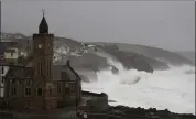  ?? ALASTAIR GRANT — THE ASSOCIATED PRESS ?? Powerful waves break on the shoreline around the small port of Porthleven in southwest England on Sunday.