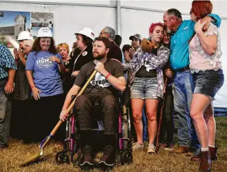  ?? Lisa Krantz / San Antonio Express-News photos ?? Kris Workman, who was shot and paralyzed, joins other survivors of the shooting at First Baptist Church of Sutherland Springs for a church groundbrea­king celebratio­n earlier this month.