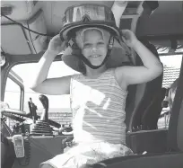  ??  ?? Evie Piner was keen to try on a fireman’s helmet when the Drouin West brigade fire truck visited Drouin Childcare centre.