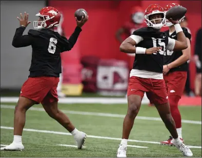  ?? (NWA Democrat-Gazette/Andy Shupe) ?? University of Arkansas quarterbac­ks KJ Jackson (right) and Jacolby Criswell (6) participat­e in passing drills Thursday during the Razorbacks’ first spring practice inside the Walker Pavilion in Fayettevil­le. More photos at nwaonline.com/38uaspring/.