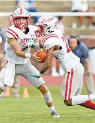  ?? STAFF PHOTO BY ROBIN RUDD ?? Ooltewah quarterbac­k Fisher Perry hands off to Tacoda Jones during the Owls’ game at Red Bank on Aug. 27. Perry’s team visits Bradley Central tonight for a Region 2-6A game.