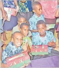  ?? Picture: JONACANI LALAKOBAU ?? Left: Children receive their gifts from the Samaritan Purse Operation Christmas Child this month.