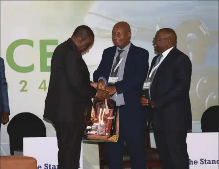  ?? ?? Alpha Media Holdings CEO Kenias Mafukidze (right) shares a lighter moment with Vice President Constantin­e Chiwenga (left) at the recently held Internatio­nal Renewable Energy Conference organised by The Standard in conjuction with the Energy ministry