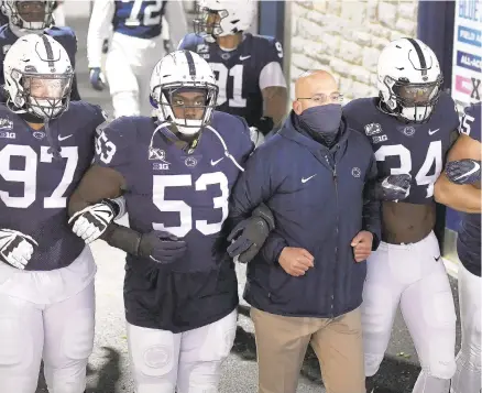  ?? BARRY REEGER/AP ?? Penn State head coach James Franklin leads his team onto the field against Illinois in December.