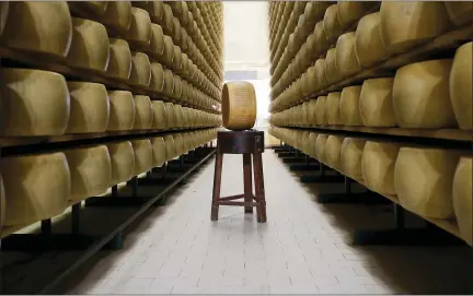  ?? PHOTOS BY ANTONIO CALANNI — THE ASSOCIATED PRESS ?? Parmigiano Reggiano Parmesan cheese wheels are stored in Noceto, near Parma, Italy. U.S. consumers are snapping up Italian Parmesan cheese ahead of an increase in tariffs to take effect next week. The agricultur­al lobby Coldiretti on Friday said sales of both Parmigiano Reggiano and Grana Padano, aged cheeses defined by their territory of origin, have skyrockete­d by 220% since the higher tariffs were announced one week ago.