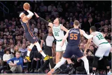  ?? (AP photo/John Minchillo) ?? New York Knicks guard Trevor Keels (3) shoots over Boston Celtics forward Blake Griffin (91) Monday during the first half of an NBA basketball game in New York.