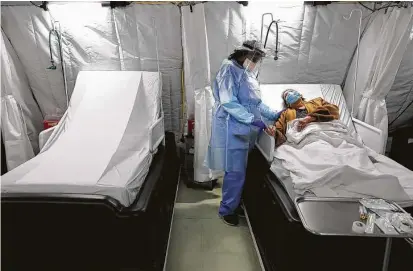  ?? Photos by Bob Owen / Staff photograph­er ?? Nurse Jave Blackburn comforts COVID-19 patient Alma Stokes in the infusion tent unit at Coventry Hospital in Lubbock.