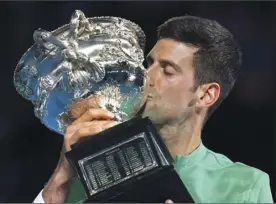 ?? AP photo ?? Novak Djokovic kisses the trophy after his win over Daniil Medvedev in the men’s singles final at the Australian Open on Sunday.