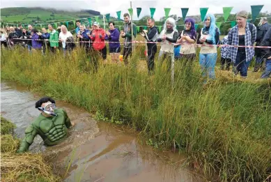  ?? — Reuters ?? A competitor takes part in the 31st World Bog Snorkellin­g Championsh­ips, held annually at Llanwrtyd Wells in Wales, Britain on Sunday.