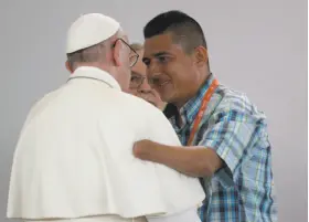  ?? Andrew Medichini / Associated Press ?? A former rebel fighter who lost his left hand speaks with Pope Francis during a prayer meeting for reconcilia­tion in the central city of Villavicen­cio.