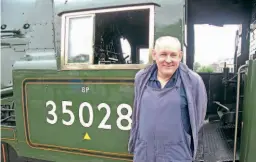  ?? ?? Left: Fireman Dave Proctor, driver Wayne Thompson, inspector Geoff Ewens, and Merchant Navy Locomotive Preservati­on Society engineer Dave Easson with Clan Line at London Victoria, prior to departure with the ‘John Farrow Salute' on August 18. ALAN RAWLINGS
Right: Driver Wayne Thompson with Clan Line at Salisbury on August 18. DON BENN