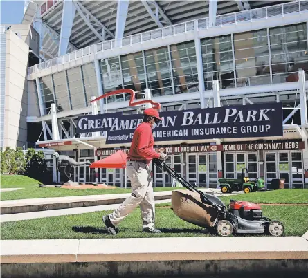  ?? SAM GREENE/ THE CINCINNATI ENQUIRER ?? The main gates are prepared Monday for opening day at Great American Ball Park in downtown Cincinnati. The Reds introduced a number of new amenities, concession­s and COVID- 19 related regulation­s.