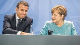  ?? Michael Kappeler / dpa via Associated Press ?? French President Emmanuel Macron, left, and German Chancellor Angela Merkel plan to discuss ways to fight terrorism at the Group of 20 summit.