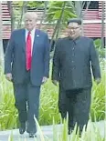  ?? AP ?? Donald Trump walks with Kim Jong-un during the Singapore Summit.