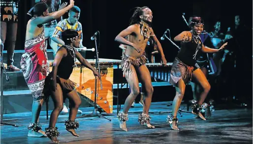  ?? Picture:WERNER HILLS ?? CURTAIN RAISER: The Eastern Cape Indigenous Music and Dance Ensemble group performs during the Official Opening Ceremony of the National Arts Festival at the Guy Butler Auditorium in Grahamstow­n