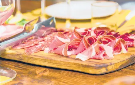  ?? ADDIE MANNAN PHOTOGRAPH­Y ?? Prosciutto produced on a small family farm in Tuscany is an example of the region’s classic cuisine.