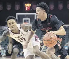  ?? Phelan M. Ebenhack / Associated Press ?? Maryland’s Anthony Cowan Jr., who scored 30 points, drives to the basket as Temple’s Nate Pierre-louis is on defense.