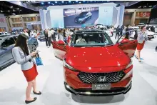  ?? EPA-Yonhap ?? Visitors inspect Honda cars displayed at the 40th Thailand Internatio­nal Motor Expo 2023 in Bangkok in this 2023 photo.