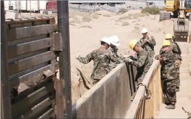  ?? The Associated Press ?? Utah National Guard troops work on a border wall in San Luis, Ariz. in 2006. National Guard troops are headed back to the border under orders from U.S. President Donald Trump.