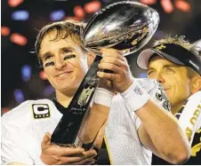  ?? JULIE JACOBSON 2010 AP FILE ?? Saints quarterbac­k Drew Brees (9) celebrates with the Vince Lombardi Trophy after the Saints won the 2010 Super Bowl vs. the Colts.