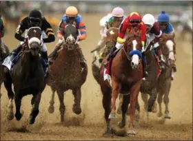  ?? AP PHOTO/ANDRES KUDACKI ?? Justify (1), with jockey Mike Smith up, leads the pack as it approaches the first turn during the 150th running of the Belmont Stakes horse race, Saturday, June 9, 2018, in Elmont, N.Y.