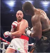  ?? JULIAN FINNEY/GETTY IMAGES ?? World heavyweigh­t champ Tyson Fury (left) beat Dillian Whyte on Saturday in London for his 32nd win in 33 profession­al bouts.