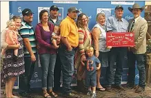  ?? SUBMITTED PHOTO ?? The Dykstra family from Burdett celebrates its B.M.O Farm Family Award presentati­on at the Calgary Stampede. The Dykstra family farm won the award for the County of 40 Mile this year.