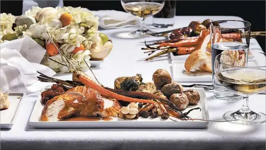  ?? E. JASON WAMBSGANS/CHICAGO TRIBUNE; MARK GRAHAM/FOOD STYLING ?? Roast turkey adds a bit of sweetness and fire (from maple and smoked salt), while the sides take on complement­ary spice notes.