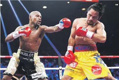  ?? Picture: Reuters ?? TAKE THAT! Floyd Mayweather lands a left to the face of Manny Pacquiao in the 11th round of their welterweig­ht world title fight in Las Vegas on Saturday.