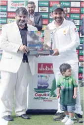  ?? — AFP ?? Sarfraz Ahmed (R) of Pakistan and his son Mohammed Abdulla (front R) pose with the trophy after the end of day four of the second Test against Australia in Abu Dhabi.