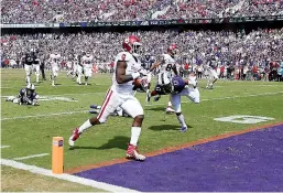  ?? AP Photo/ Brandon Wade ?? ■ Oklahoma running back Trey Sermon (4) scores a touchdown during the second half of an NCAA football game against TCU Saturday in Fort Worth, Texas. Oklahoma won, 52-27.