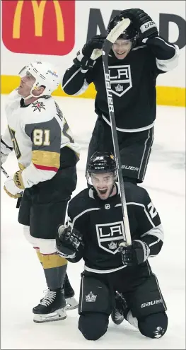  ?? MARK J. TERRILL — THE ASSOCIATED PRESS ?? Kings defenseman Sean Walker, below, celebrates his goal Sunday along with teammate Trevor Moore, top, as Golden Knights center Jonathan Marchessau­lt skates away.