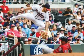  ?? AP PHOTOS/JOHN AMIS ?? The Washington Nationals’ Juan Soto steals third base as Atlanta Braves third baseman Charlie Culberson tries to make a tag after going high for the ball during the fourth inning of Saturday’s game in Atlanta.