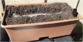  ??  ?? An EarthBox readied with soil and included fertilizer. Dolomite has also been added.