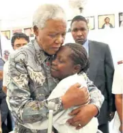  ??  ?? Gqokinsimb­i Qwabe (behind) providing security for Madiba at one of the many engagement­s for the late former statesman