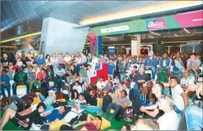  ??  ?? Passengers watch a World Cup game at the Qatar Fan Zone at HIA.