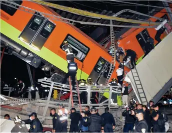  ?? — AFP file photo ?? Rescue workers at the site of a metro train accident after an overpass for a metro partially collapsed in Mexico City.