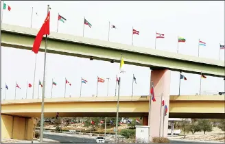  ??  ?? A picture taken on Feb 9 shows flags of the 70 countries participat­ing in the Kuwait Internatio­nal Conference for
Reconstruc­tion of Iraq, flying along a highway in the capital Kuwait City. (AFP)