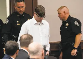  ?? Ben Gray / Associated Press ?? 0obert aron ong, 22, enters Su¸erior ourt in anton, Ga., where he ¸leaded guilty to four counts of murder at an tlantaarea massage business.